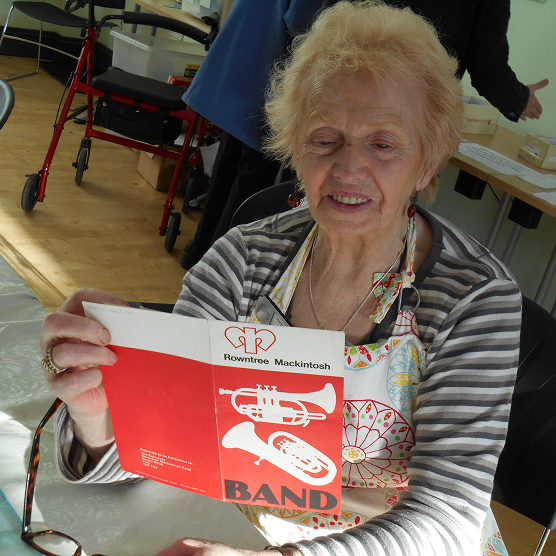 Older lady looking at Rowntrees band leaflet